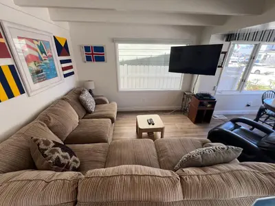 a living room with a couch and a flat screen tv at 327 Alvarado Pl in Newport Beach
