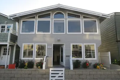 a house with large windows and a porch at 327 Alvarado Pl in Newport Beach