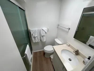 a bathroom with a toilet and a sink and a shower at 327 Alvarado Pl in Newport Beach
