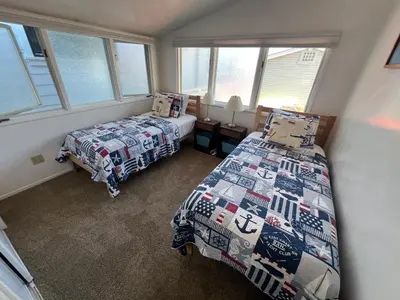 two beds in a room with two windows at 327 Alvarado Pl in Newport Beach