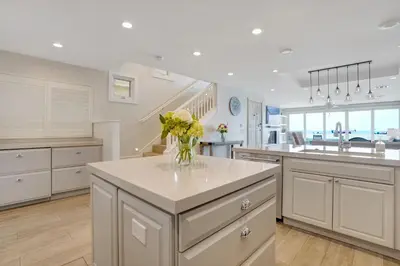a kitchen with a vase of flowers on a counter at 3312 W Oceanfront in Newport Beach