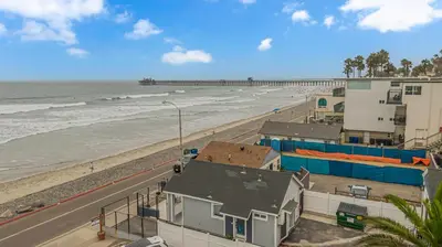 a view of a beach with buildings and the ocean at The Shining Sea Crab in Oceanside