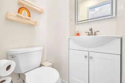 a bathroom with a white toilet and a sink at The Shining Sea Octopus in Oceanside