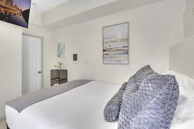 a white bedroom with a large bed in it at The Shining Sea Octopus in Oceanside