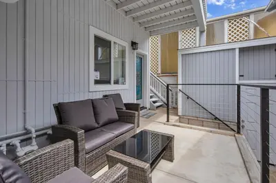 a porch with a couch on a patio at The Shining Sea Octopus in Oceanside