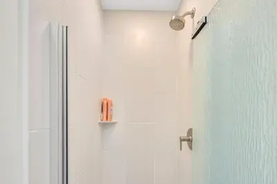 a bathroom with a shower with a glass door at The Shining Sea Octopus in Oceanside