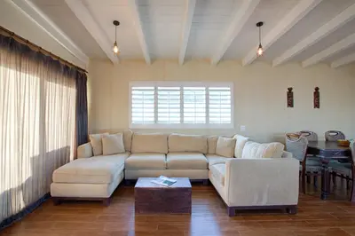 a living room with a couch and a table at 3600 W Oceanfront in Newport Beach