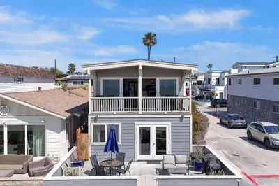 a white house with a porch and a patio at 3600 W Oceanfront in Newport Beach