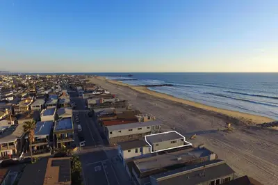 an aerial view of a beach and the ocean at 3600 W Oceanfront in Newport Beach