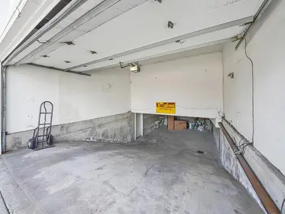 an empty parking garage with a sign on the wall at 3607 Seashore Dr B in Newport Beach