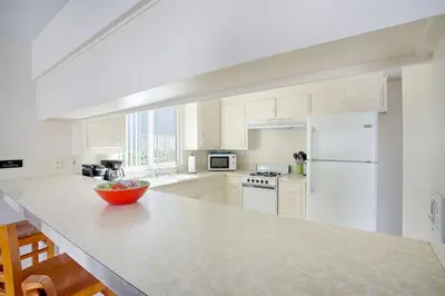 a kitchen with white cabinets and a white refrigerator at 3610 Seashore Dr in Newport Beach