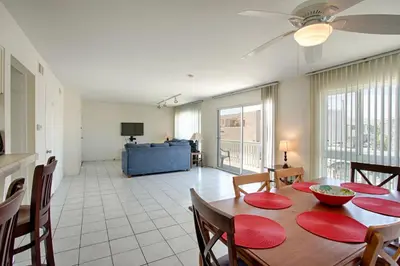 a dining room with a table and a living room at 3612 Seashore Dr in Newport Beach