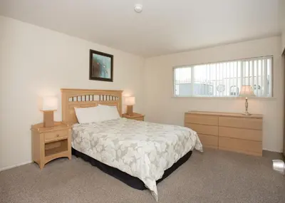 a bedroom with a bed and two night stands and a window at 3612 Seashore Dr in Newport Beach