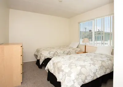 a bedroom with two beds and a window at 3612 Seashore Dr in Newport Beach