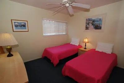 a room with two beds and a ceiling fan at 4210 Seashore Dr in Newport Beach
