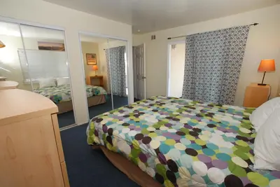 a bedroom with a bed and a mirror at 4210 Seashore Dr in Newport Beach