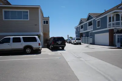 two cars parked in a parking lot next to buildings at 4210 Seashore Dr in Newport Beach