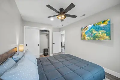 a bedroom with a blue bed and a ceiling fan at Modern Oasis New 2BR in La Mesa in La Mesa