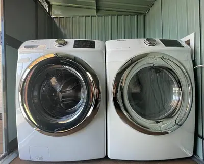 a washing machine and a dryer sitting next to each other at Bungalow near zoo and beach with AC, EV, private yard in San Diego