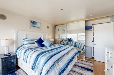 a bedroom with a bed and a mirror at Tranquil Escape Bayside in San Diego