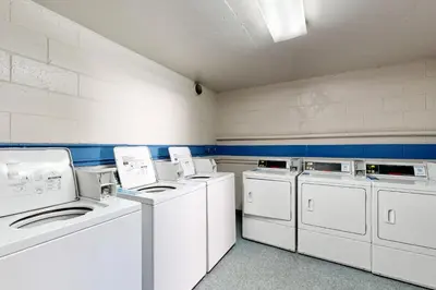 a laundry room with white washers and dryers at Tranquil Escape Bayside in San Diego