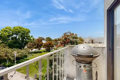 a lamp on a balcony with a view of a park at Tranquil Escape Bayside in San Diego