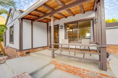 a patio with a wooden pergola on a house at Sail Bay Dream - Steps to the bay! in San Diego