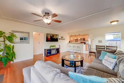 a living room with a couch and a table at Sail Bay Dream - Steps to the bay! in San Diego