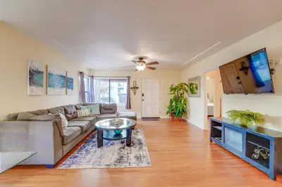 a living room with a couch and a table at Sail Bay Dream - Steps to the bay! in San Diego