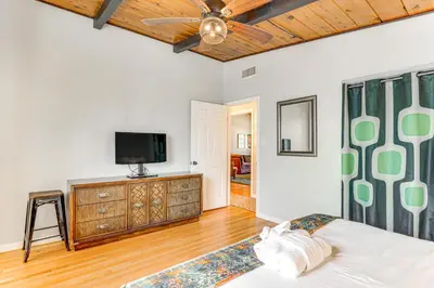 a bedroom with a bed and a flat screen tv at Peaceful Vista House with Gas Grill 1 Mi to Dtwn! in Vista