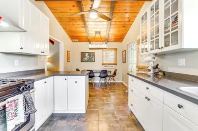 a kitchen with white cabinets and a wooden ceiling at Peaceful Vista House with Gas Grill 1 Mi to Dtwn! in Vista