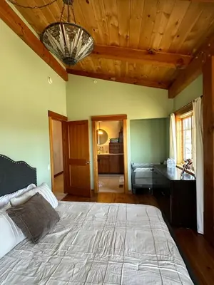 a bedroom with a large bed and a wooden ceiling at Sunset-Ridge in Alpine