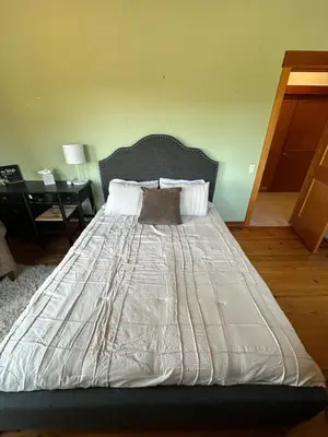 a large bed in a bedroom with a desk at Sunset-Ridge in Alpine