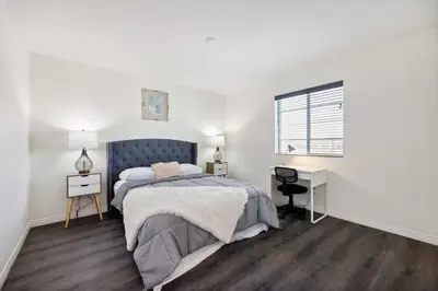 a bedroom with a bed and a desk and a window at Entire Private Home with 5 Bedrooms 3 Bathrooms, 3000 sqft, Gated Yard, Garage, Nice View, Available Now in Menifee