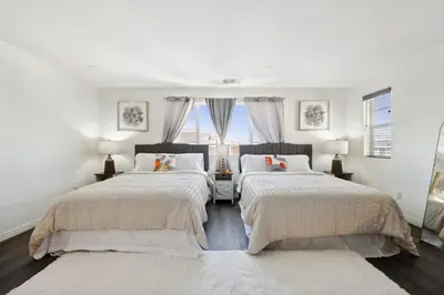 two beds in a white room with windows at Entire Private Home with 5 Bedrooms 3 Bathrooms, 3000 sqft, Gated Yard, Garage, Nice View, Available Now in Menifee