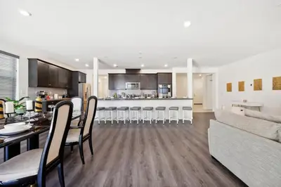 a kitchen and living room with a table and a couch at Entire Private Home with 5 Bedrooms 3 Bathrooms, 3000 sqft, Gated Yard, Garage, Nice View, Available Now in Menifee