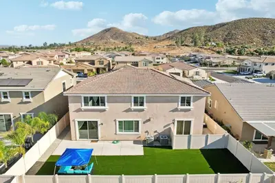 an aerial view of a house with a yard at Entire Private Home with 5 Bedrooms 3 Bathrooms, 3000 sqft, Gated Yard, Garage, Nice View, Available Now in Menifee