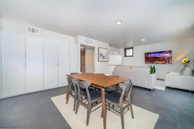 a kitchen and dining room with a wooden table and chairs at City24 Condo Hotel Little Italy Mission Hills in San Diego