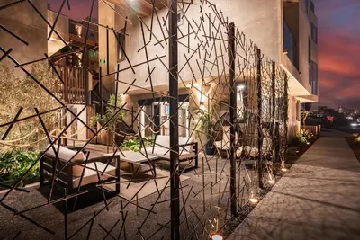 a building with a group of chairs and lights at City24 Condo Hotel Little Italy Mission Hills in San Diego
