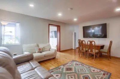 a living room with a couch and a table at 100 Yards Ocean & Surfing Ocean Views Backyard in San Diego