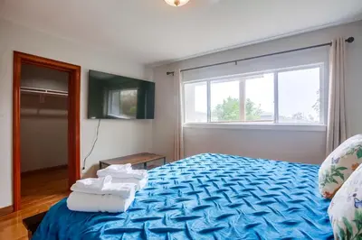 a bedroom with a blue bed with towels on it at 100 Yards Ocean & Surfing Ocean Views Backyard in San Diego