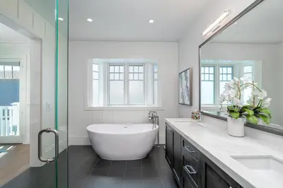a bathroom with a tub and a large mirror at 1225 W Balboa Blvd B in Newport Beach