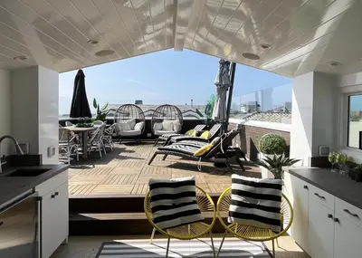 a patio with chairs and a table on a deck at 1225 W Balboa Blvd B in Newport Beach