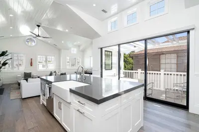 a kitchen with white cabinets and a large window at 1225 W Balboa Blvd B in Newport Beach