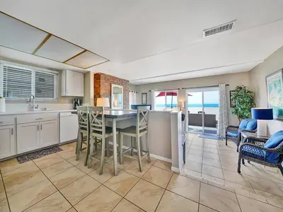 a kitchen with a table and chairs in a room at 3607 Seashore A & B in Newport Beach