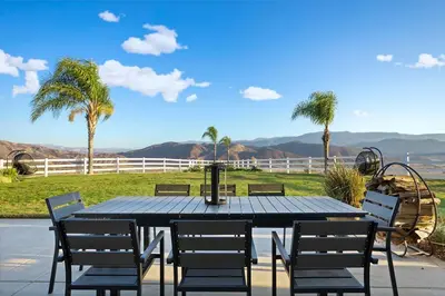 a table and chairs with a view of a playground at Grenache Estate - Nestled in Temecula Wine Country in Temecula