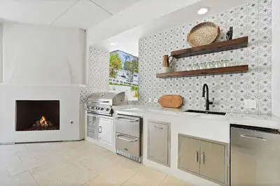 a kitchen with a stove and a fireplace at Villa Rosa in Temecula