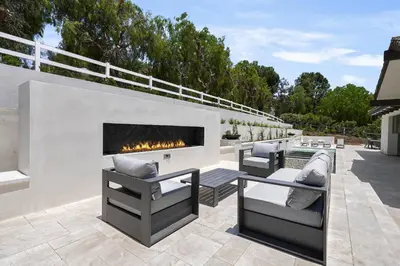 a patio with two couches and a fireplace at Villa Rosa in Temecula