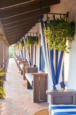 a row of benches with potted plants on a building at Casa Laguna Hotel & Spa in Laguna Beach