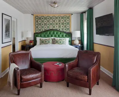 a bedroom with a bed and two chairs at Casa Laguna Hotel & Spa in Laguna Beach